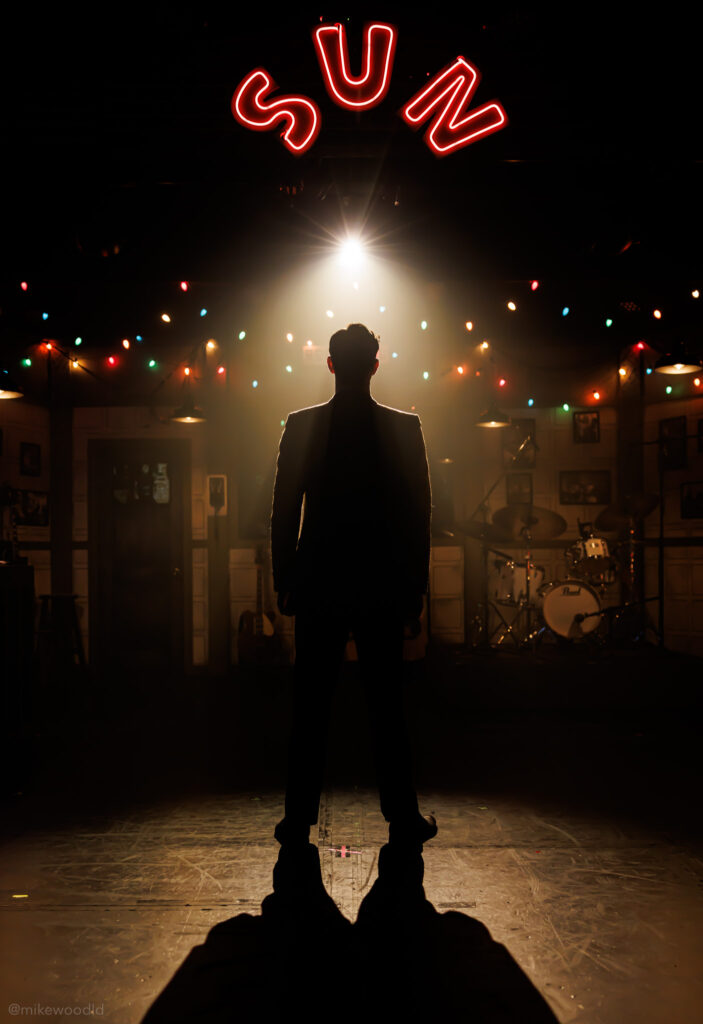 Production photo from Million Dollar Quartet — single overhead source, sharp shadows on the floor