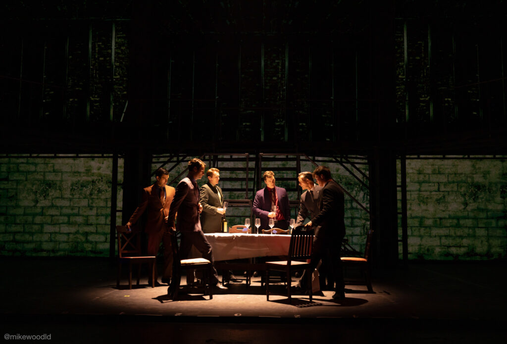 Jersey Boys — basement scene, single hanging-bulb source, white tablecloth bouncing light onto faces