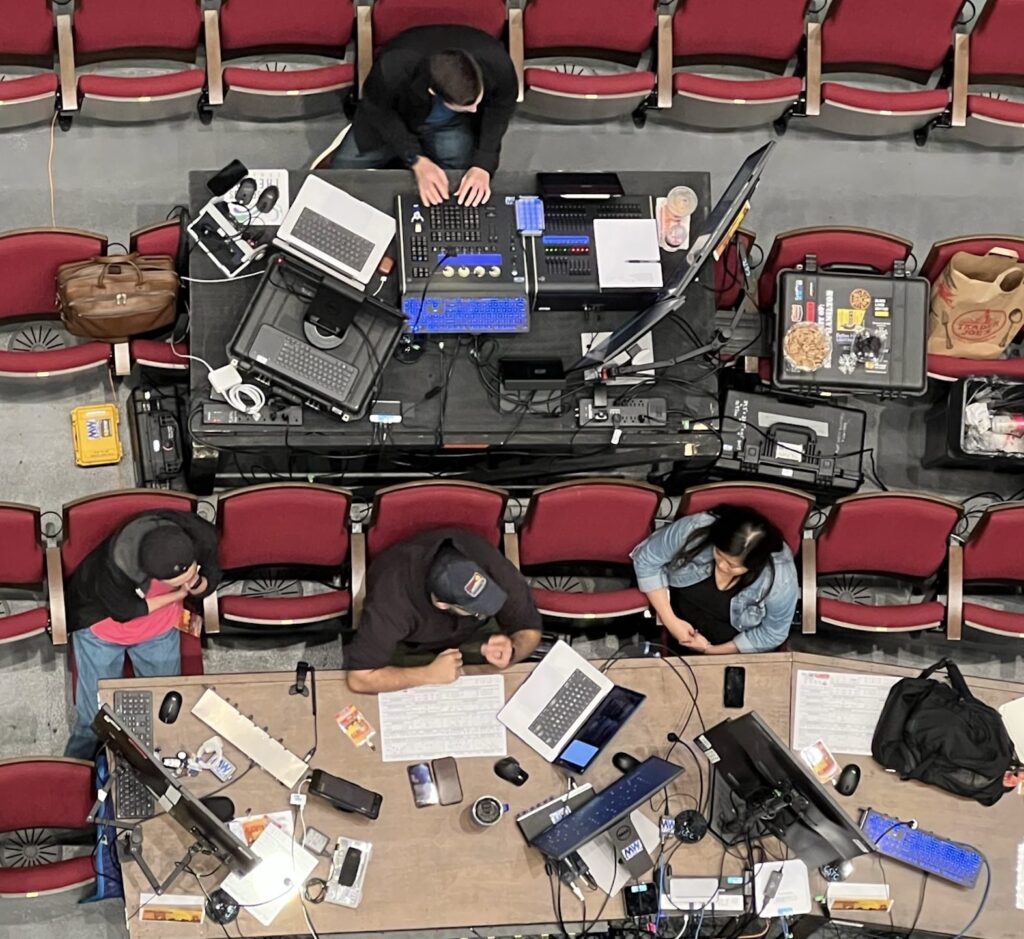 The In The Heights tech table during Brad Fetter's 2022 apprenticeship year, overhead view of the design and programming team at work.