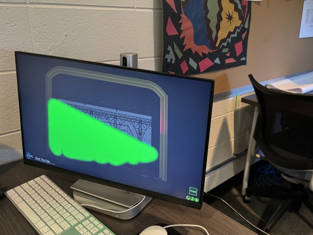 An Eos previsualization of a lit stage on a monitor at a student programming workstation.