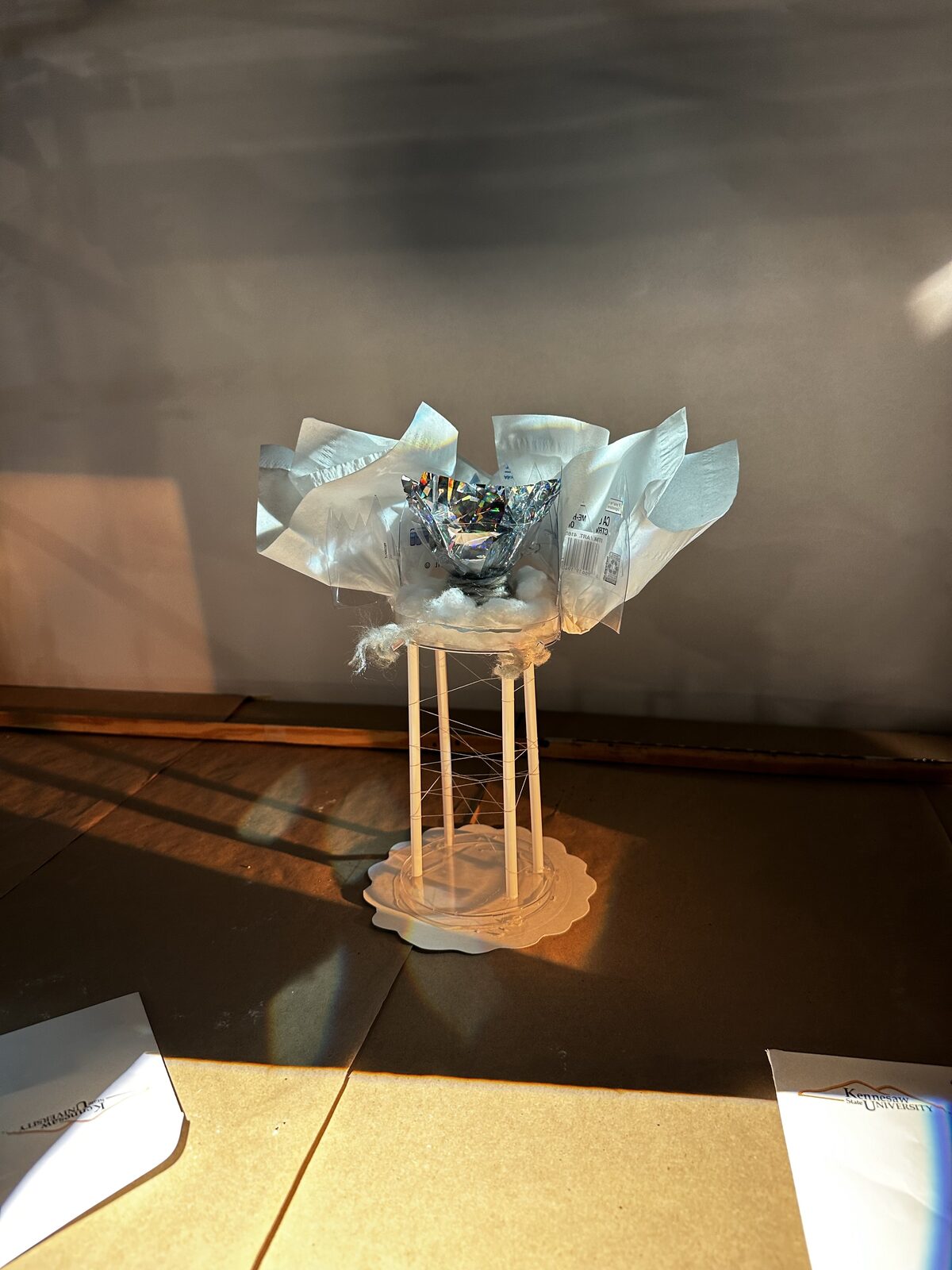 Livia Stetson · Painting with Light: the Form & Texture model lit with a narrowed front light on the silver torch, R363 blue from the back corner, and warm E316 across the pillars